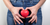 woman with heart in front of lower belly
